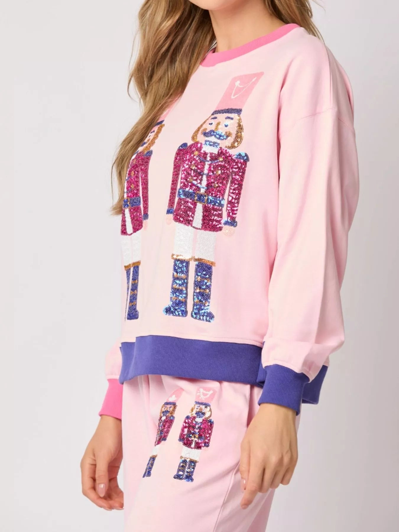Pink pajama set with robot design on a plain background