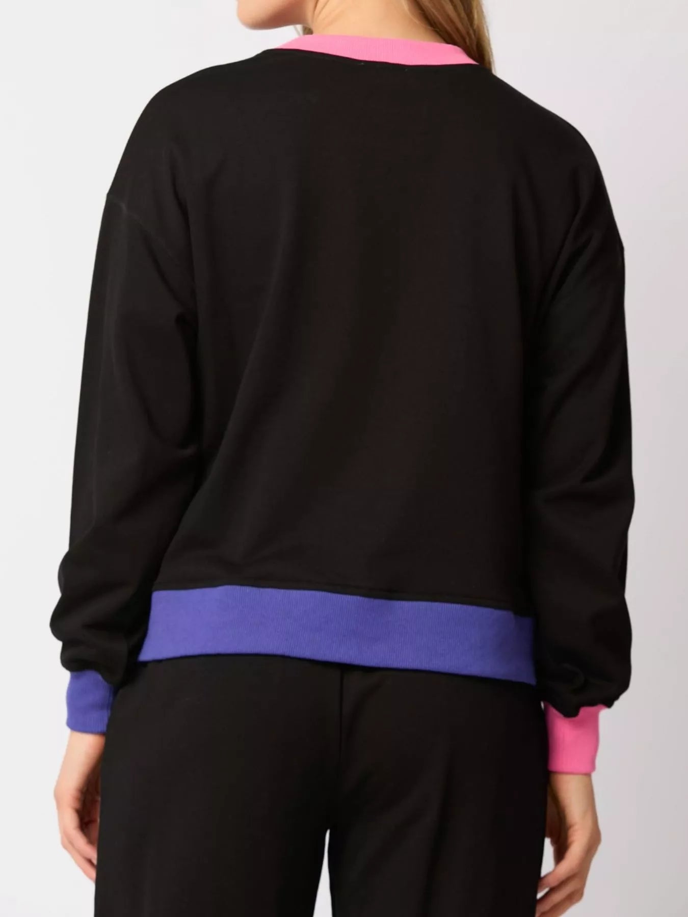 Black sweater with colorful cuffs and hem on a white background