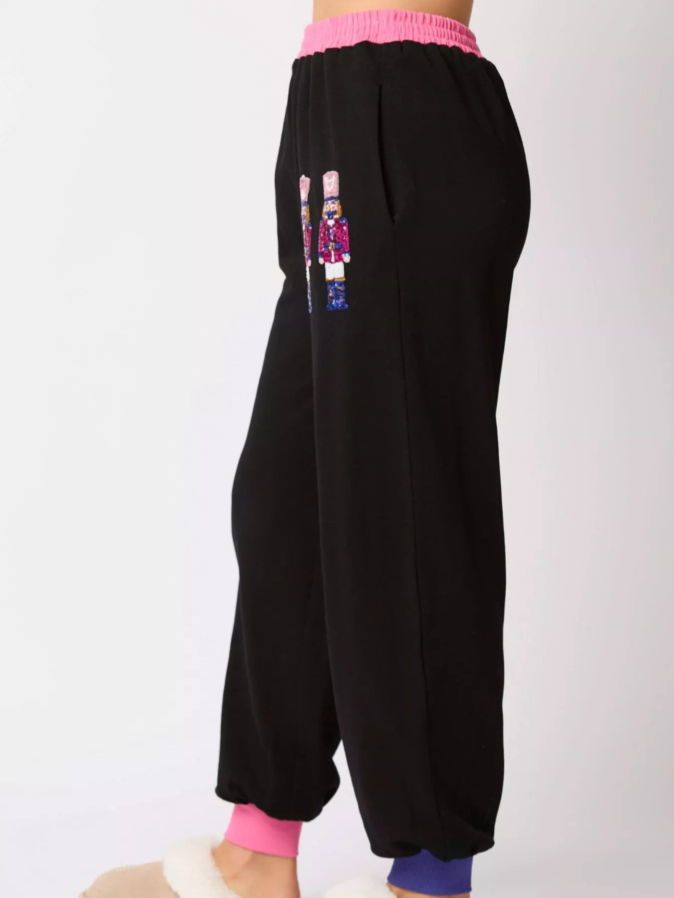 Black baggy pants with colorful design on a white background